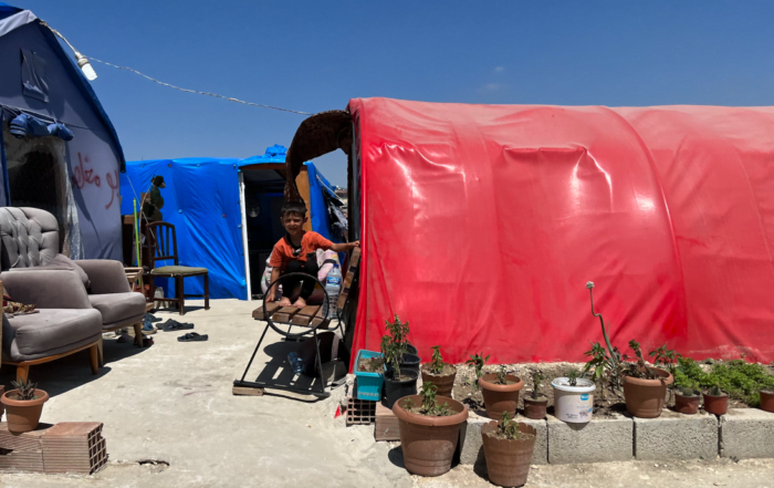 Boy outside tent in refugee camp